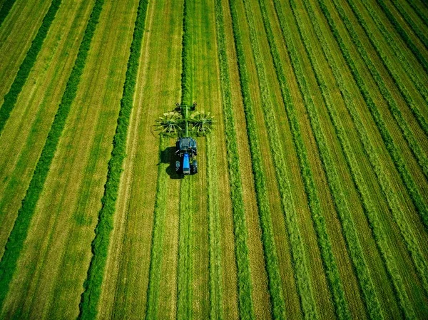 Aerial view of Tractor mowing green field in Finland. — Stock Photo, Image