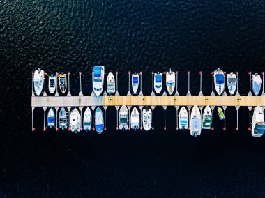 Aerial view of boats, yachts, water bike and wooden sauna in a marina in Finland clipart