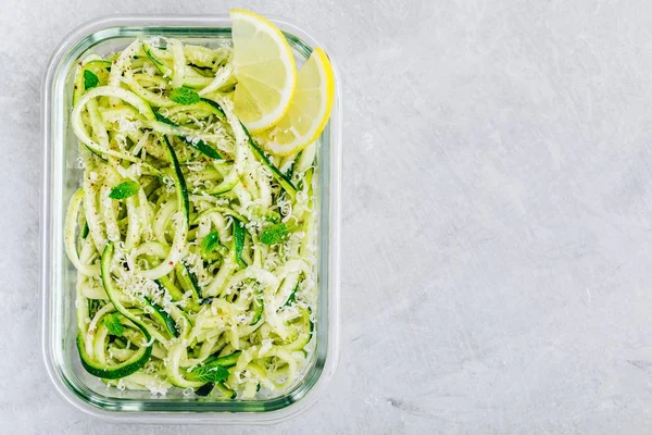 Meal prep lunch box containers Spiralized zucchini noodles pasta with mint, lemon and parmesan cheese