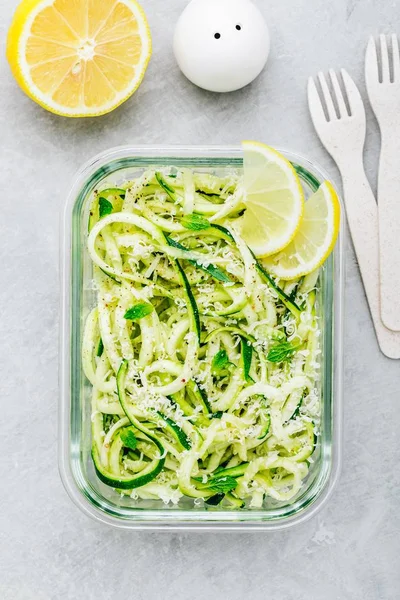 Meal prep lunch box containers Spiralized zucchini noodles pasta with mint, lemon and parmesan cheese