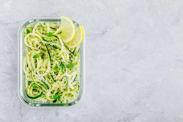 Meal prep lunch box containers Spiralized zucchini noodles pasta with mint, lemon and parmesan cheese