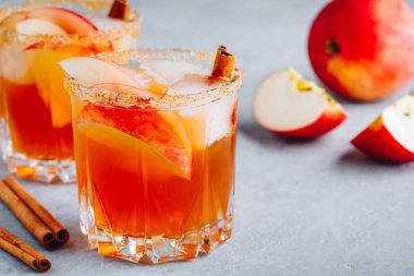 Harvest apple punch with cinnamon and ice for Halloween or Thanksgiving in glass 