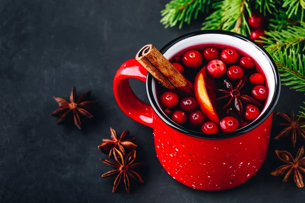 Traditional Christmas Mulled Wine drink with cranberries, orange slices and spices in red mug — Stock Photo, Image