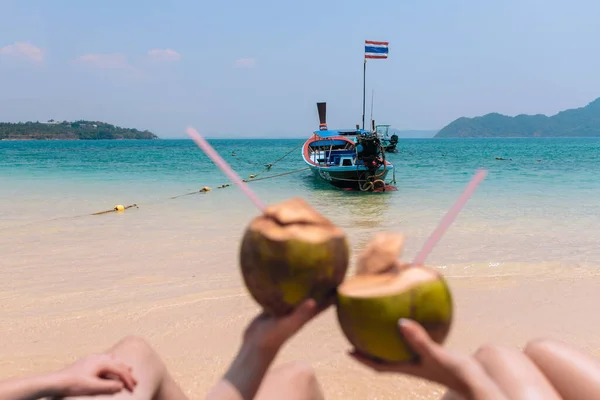 Close-up Of Couples Hand Holding Coconut With Drinking Straw In Front Of Idyllic — Stock Photo, Image