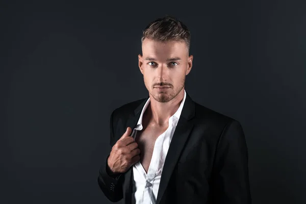 Portrait of a young man in a studio suit