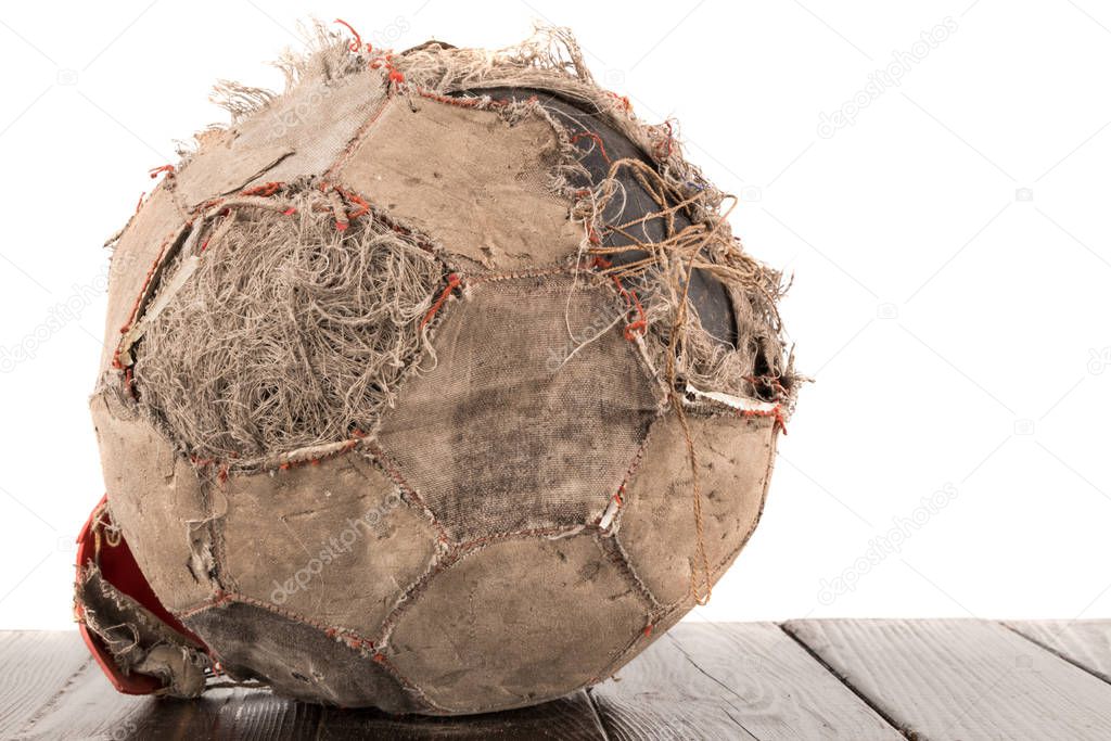Old torn soccer ball on white background