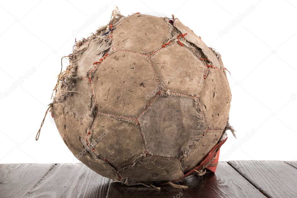 Old torn soccer ball on white background