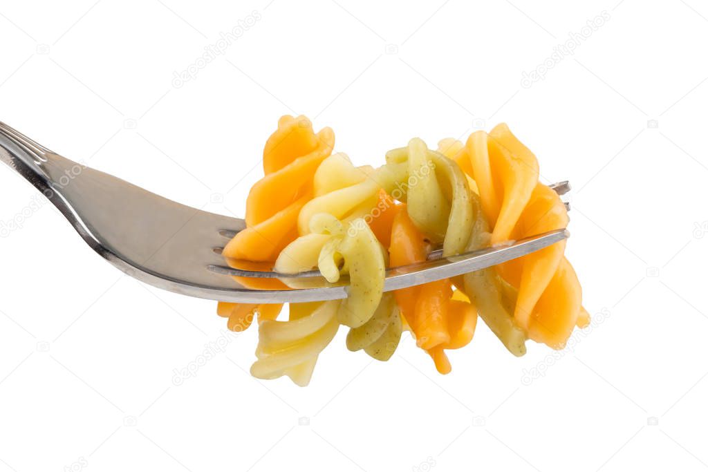 Colored pasta on a fork close-up on a white isolated background