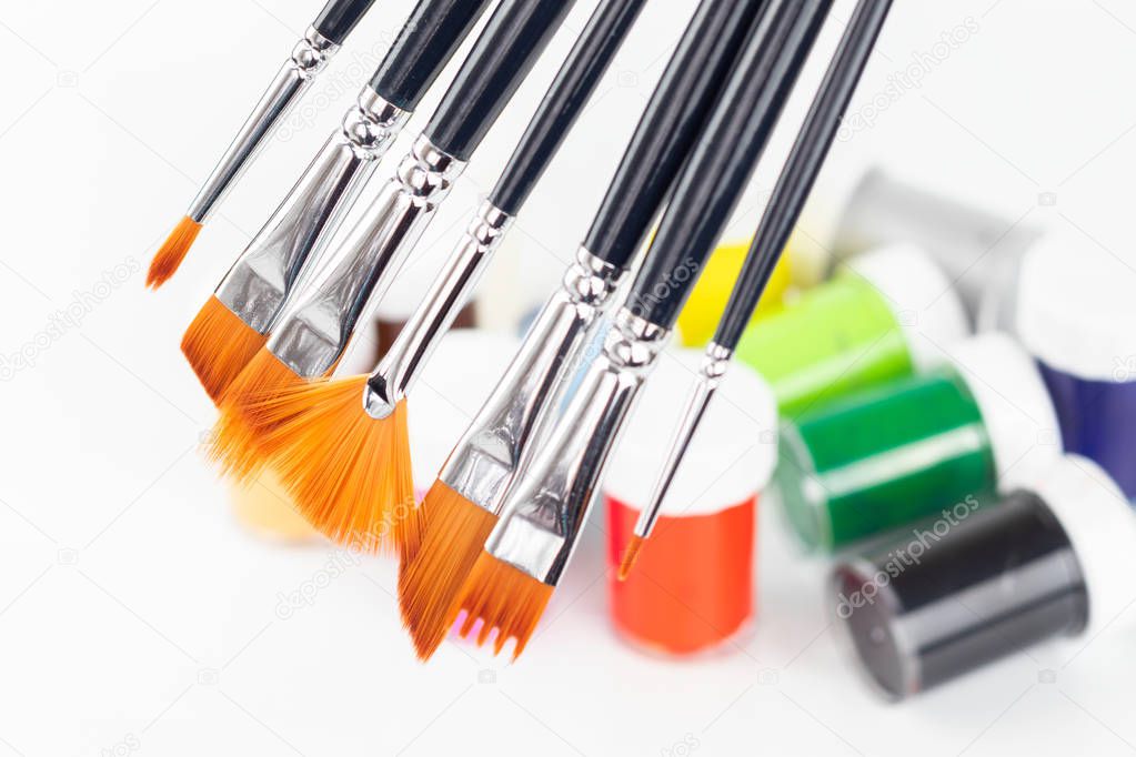Various brushes and colorful paint for painting. Close-up. 