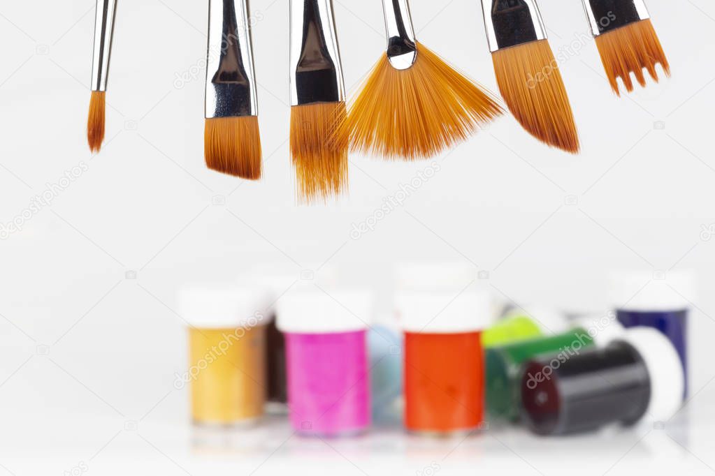 Various brushes and colorful paint for painting. Close-up. A place for your text.