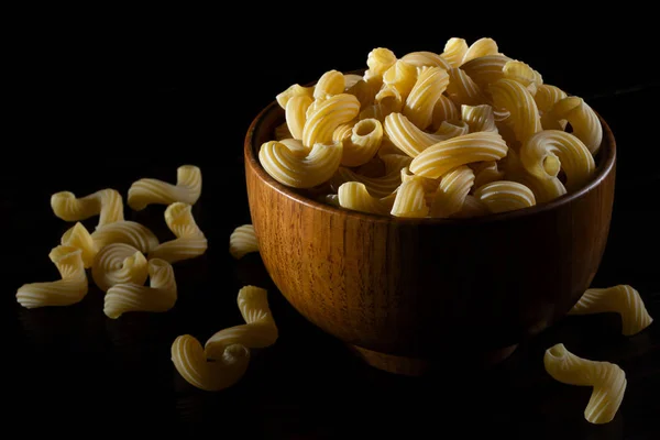 意大利生意大利面卡瓦塔皮在一个木制碗在黑暗的背景 — 图库照片