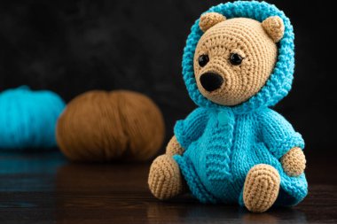 Funny knitted toy bear. Amigurumi toy. Crochet stuffed animals. clipart