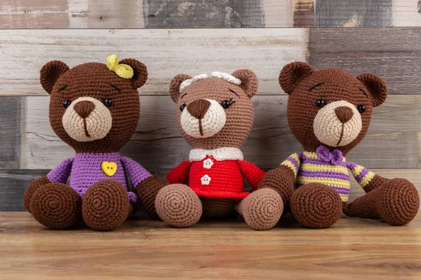Three funny toy knitted bears. Amigurumi toy. Crochet stuffed animals.