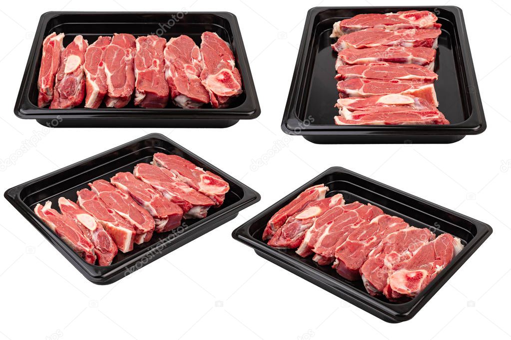 Pieces of fresh raw meat in a black plastic container on a white isolated background. Ready for sale. 