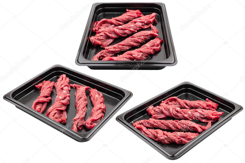 Pieces of fresh raw meat packed in plastic packaging. Ready for sale. White isolated.