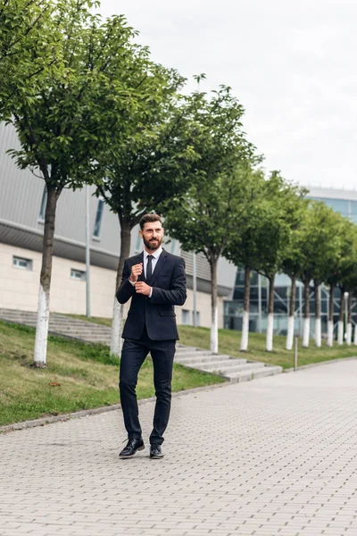 businessman in an expensive suit and shoes goes on the square, finances and startups