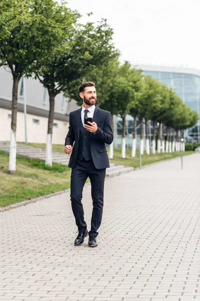 businessman in an expensive suit and shoes goes on the square, finances and startups