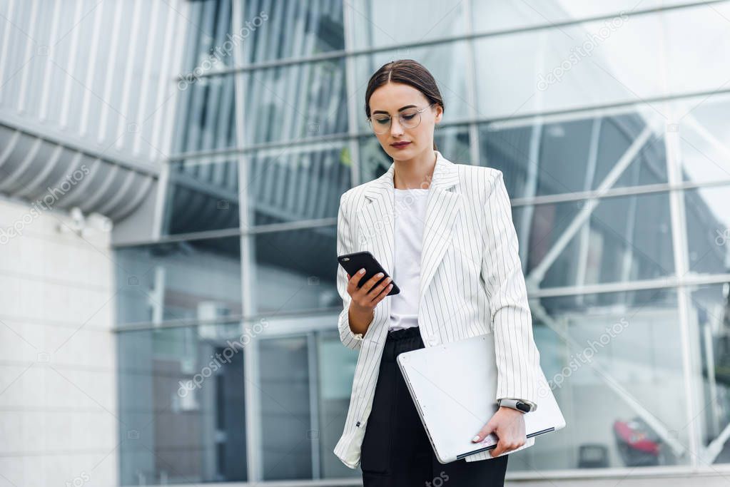 Successful businessman working at laptop. Business woman working. Sales woman working using her laptop while writing text. Businesswoman in glasses working on-line. Mobile technology.