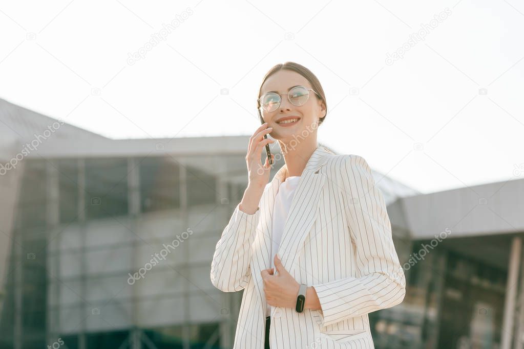 Businesswoman talking on the phone near office