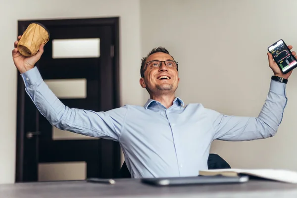 Ecstatic happy executive sales businessman cheering excited in celebration after good news