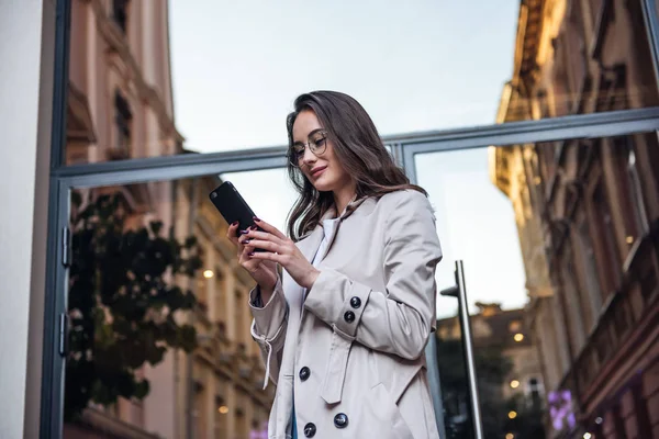 Business woman talking on smart phone. Business people office worker talking on smartphone smiling happy. Young multiracial Asian / Caucasian female professional outside.