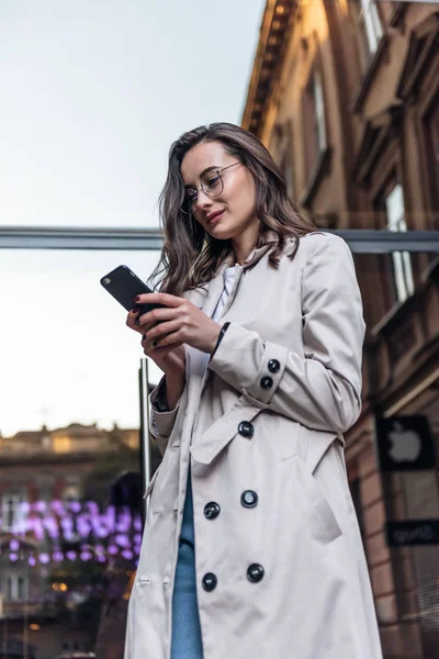 Business woman talking on smart phone. Business people office worker talking on smartphone smiling happy. Young multiracial Asian / Caucasian female professional outside.