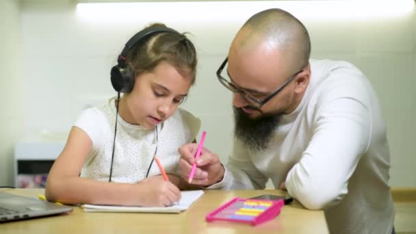 Father and daughter doing homework together. — Stock Video
