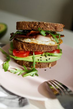 Yumurta ve pastırma bir plaka ile ekmek üzerine avokado