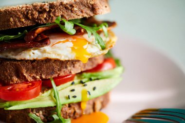 Yumurta ve pastırma bir plaka ile ekmek üzerine avokado