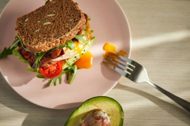 Yumurta ve pastırma bir plaka ile ekmek üzerine avokado