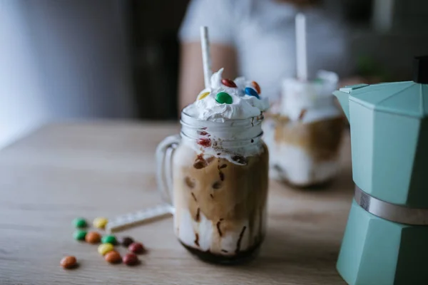 Iced Mocha Coffee With Chocolate Syrup And Button Candies