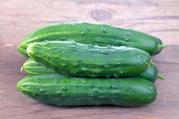 Cucumbers on rustic table — Stock Photo, Image