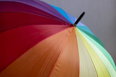 Gökkuşağı renklerinde çizgili çok renkli bir şemsiye, LGBT bayrağının bir sembolü..
