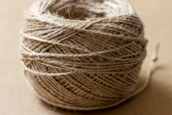 A coil of jute rope used for needlework and handicrafts.