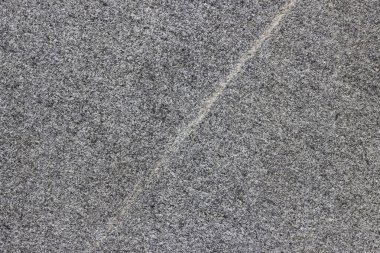 Parlatılmış granitten yapılmış doğal bir taş levhanın dokusu..