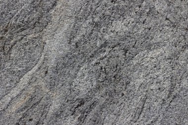 Parlatılmış granitten yapılmış doğal bir taş levhanın dokusu..