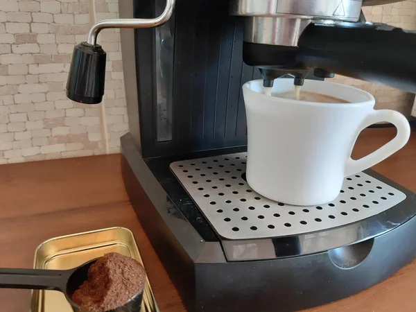 In the photo, the process of brewing coffee on a coffee machine.