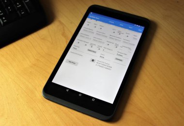 Tablet device on a desk running app with corner of keyboard showing