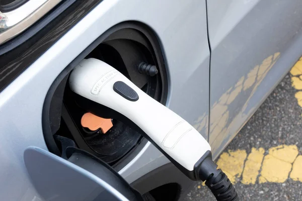 電源ソケットはバッテリーへの充電のために電気自動車に接続します — ストック写真