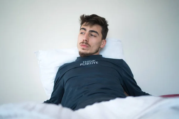 Man thinking in bed