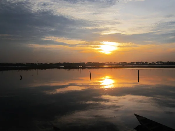 Fond ciel pendant le coucher du soleil et reflets d'eau — Photo