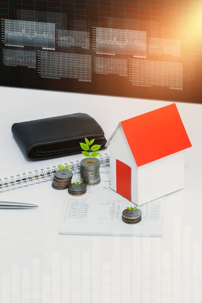saving account passbook or financial statement, paper house model, Little tree and coins on office desk table. Business, finance, property ladder or mortgage loan concept