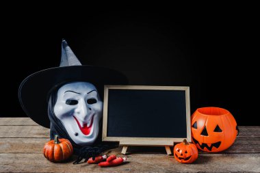 Cadılar Bayramı arka plan. Halloween Pumpkins, Siyah örümcek, ahşap zemin ve siyah arka plan üzerinde cadı maskesi Ayaklıklı kara tahta