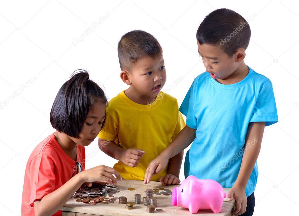 Group of asian children are helping putting coins into piggy bank isolated on white background with clipping path. Education Savings concepts
