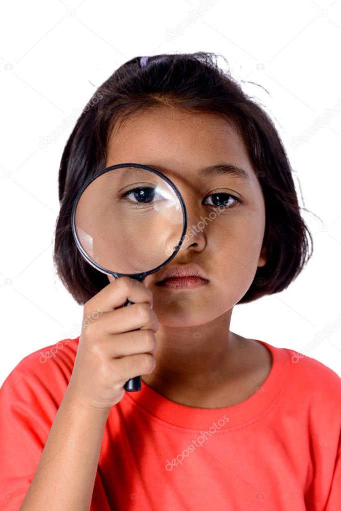 Happy kid exploring with magnifying glass isolated on white back