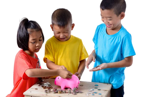 Group of asian children are helping putting coins into piggy ban Stock Image
