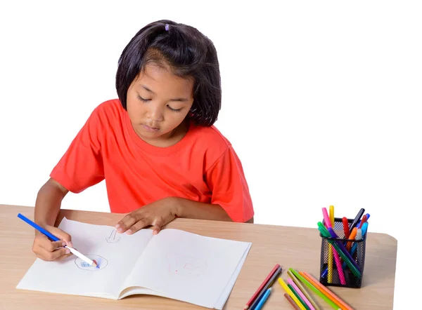 Lindo dibujo alegre niño usando lápiz de color mientras está sentado en — Foto de Stock