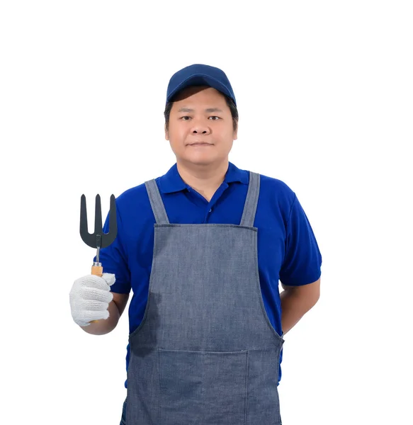 Pekerja asia berbaju biru dengan celemek dan sarung tangan pelindung — Stok Foto