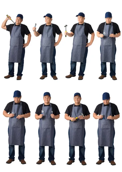 Siyah gömlek ve önlüklü bir işçi ya da askerin tüm vücut portreleri İngiliz anahtarı ya da beyaz arka planda izole edilmiş herhangi bir alet içeriyor. El yapımı, DIY konsepti