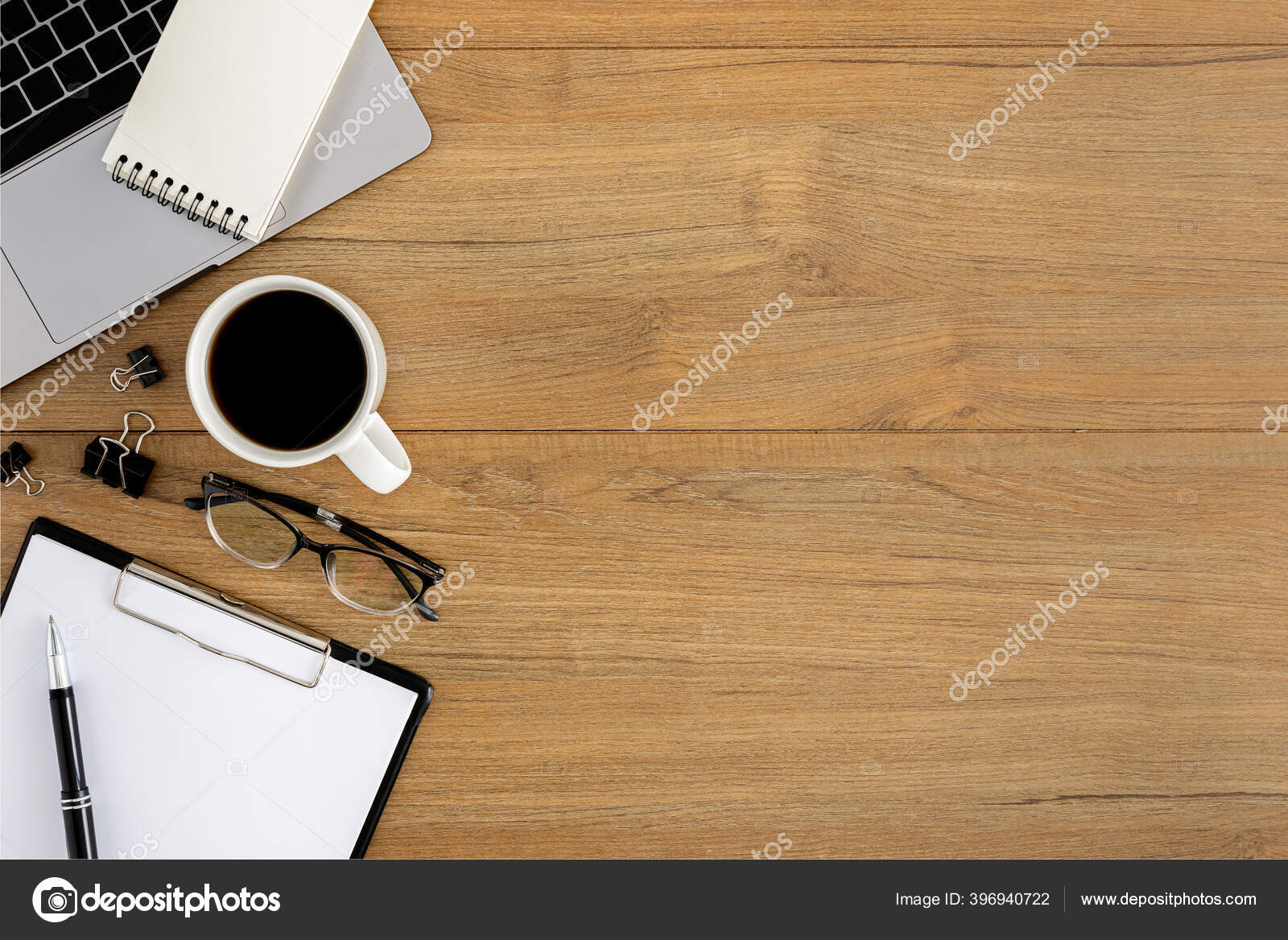 Top view of working table with blank paper notebook, cup of coffee and  eyeglasess., Stock image